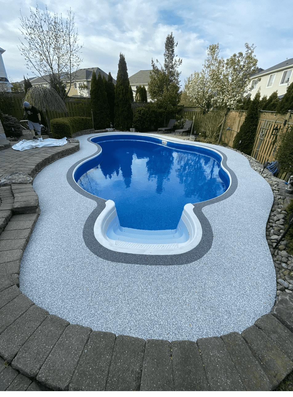 Blue poured rubber deck around a community pool